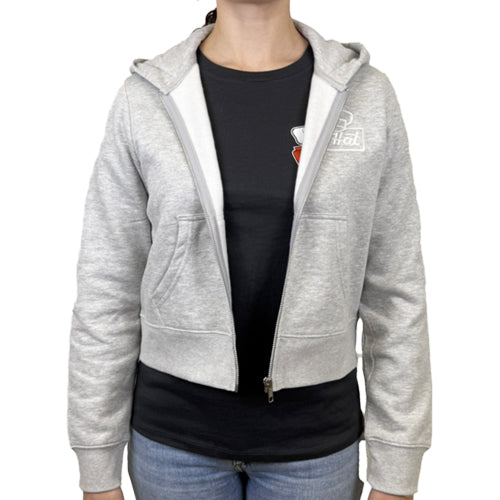 Gray hoodie with The Hat Restaurant logo worn by a person on a white background. The Hat women's fleece zipup logo hoodie.