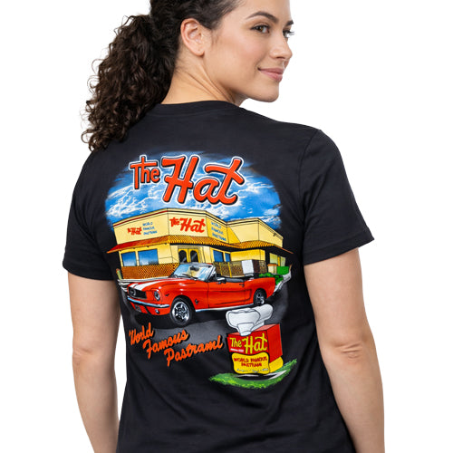 Woman wearing a black t-shirt with 'The Hat' restaurant graphic on the back. The Hat Restaurant World Famous Pastrami Los Angeles